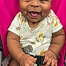 Onyx joined the competition — help win amazing prizes! baby, smiling, child, infant, onesie, giraffe_pattern, pink_chair, seatbelt, happy, cute, portrait, indoors, person, sitting, young_child, cheerful, expression, skin, hand, feet