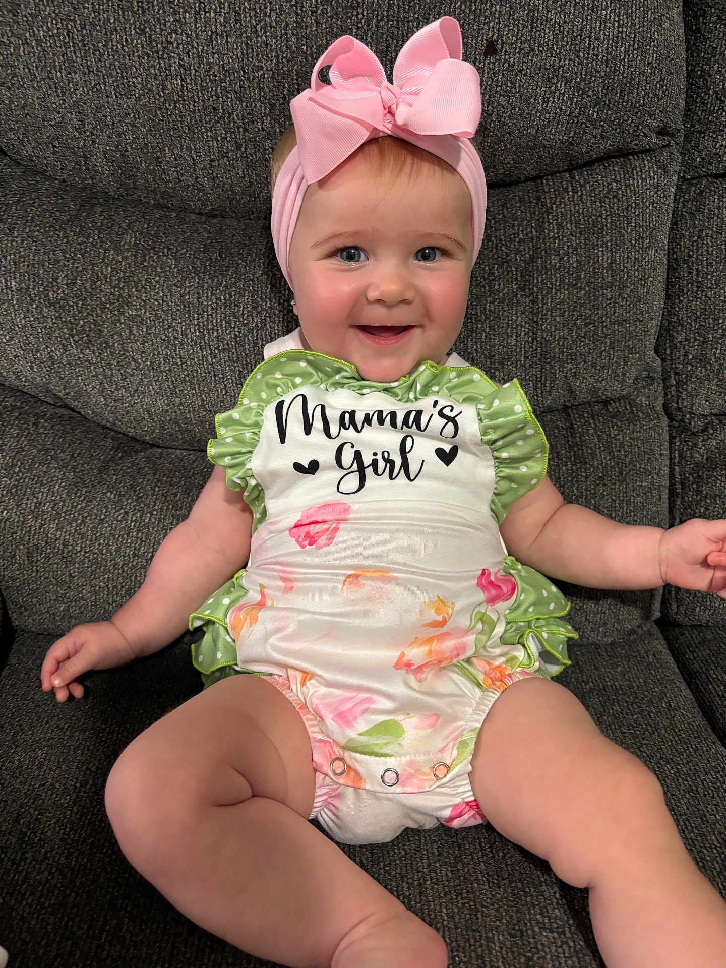 Saylor joined the competition — help win amazing prizes! baby, girl, smiling, headband, pink_bow, floral_outfit, mamas_girl_text, couch, sitting, happy, child, infant, cute, indoors, portrait, person, skin, face, clothing, comfortable