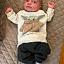 Waylon is registered to the contest to win money with this photo: baby, baby_yoda, cartoon, child, clothing, cozy, cute, expression, indoor, infant, laying_down, pants, portrait, quilted_bedspread, small_hands, soft_lighting, striped_socks, sweater, wide_eyes, young_child