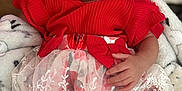 Lael is registered to the contest to win money with this photo: baby, child, sleeping, red_clothing, lace, floral_pattern, blanket, cozy, hand, infant, cute, portrait, indoor, soft_texture, peaceful, rest, newborn, fabric, toddler, wrapped