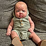 baby, infant, child, couch, furniture, clothing, romper, hood, shoes, tongue, cute, expression, sitting, indoors, texture, fabric, person, skin, legs, hands