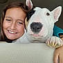 Oxane a rejoint le concours — aidez-le/la à gagner de superbes lots ! girl, dog, bull_terrier, smiling, indoor, couch, pet, child, face, happy, closeup, friendship, portrait, animal, human, affection, casual, leisure, relaxation, cute