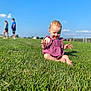 toddler, child, grass, outdoor, blue_sky, sunny_day, purple_dress, happy, smiling, barefoot, nature, playing, field, people, background, casual_clothing, summer, portrait, baby, greenery