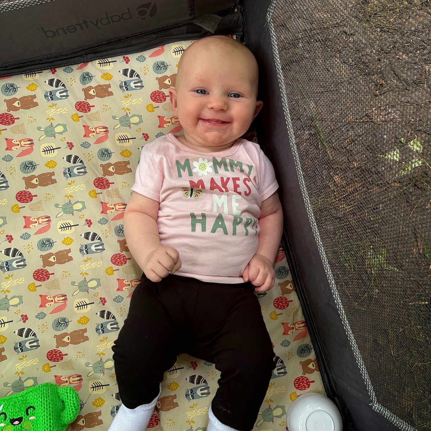 Oktavia joined the competition — help win amazing prizes! animal_pattern, baby, black_pants, bowl, child, cute, face, green_toy, happy, indoor, infant, knitted_toy, mattress, person, pink_shirt, playpen, portrait, smiling, toy, white_socks