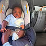 Logan joined the competition — help win amazing prizes! baby, car_seat, infant, child, white_socks, bib, car_interior, backpack, seatbelt, portrait, cute, young_child, sitting, looking_at_camera, clothing, car, person, indoor, safety, seat