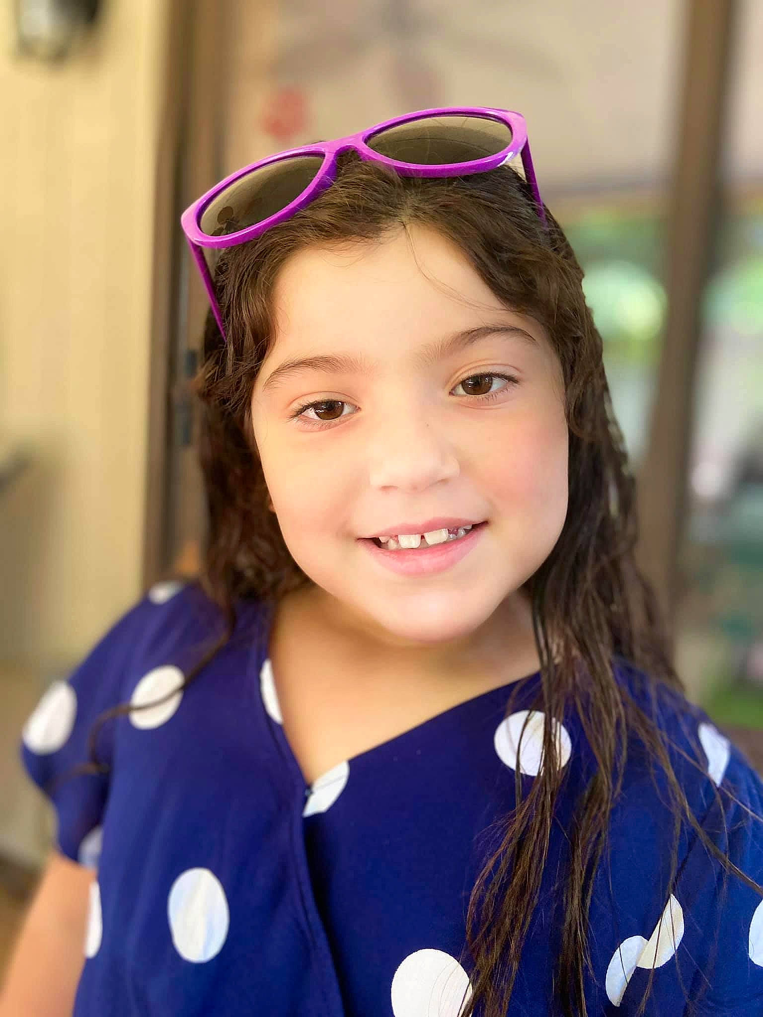 Daniella is registered to the contest to win money with this photo: child, child_model, ear, eyewear, fashion_accessory, glasses, happy, headgear, joy, person, smile, uniform, vision_care