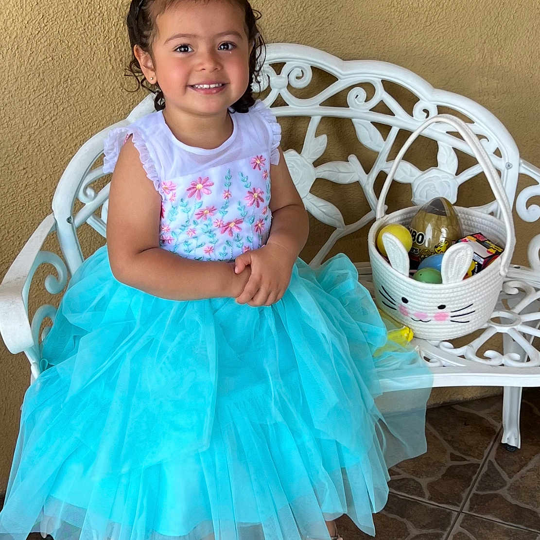 Mia joined the competition — help win amazing prizes! child, clothing, costume, dress, face, female, flagstone, footwear, furniture, girl, head, path, person, photography, portrait, sandal, shoe, sitting, skirt, walkway