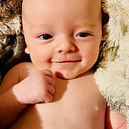 Maverick joined the competition — help win amazing prizes! baby, smile, face, blanket, skin, hand, infant, cute, portrait, child, young, soft, fuzzy, warm, comfort, expression, happy, closeup, human, newborn