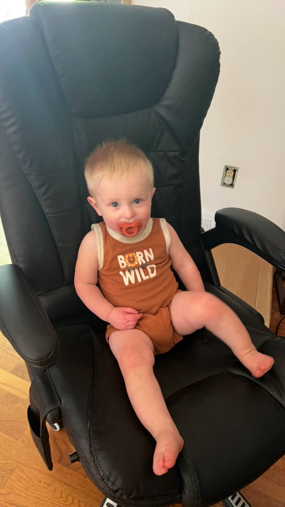Wyatt is registered to the contest to win money with this photo: arm, baby_toddler_clothing, chair, comfort, eye, finger, furniture, human_body, joint, knee, lap, leg, neck, person, shoe, shoulder, skin, stomach, thigh, thumb