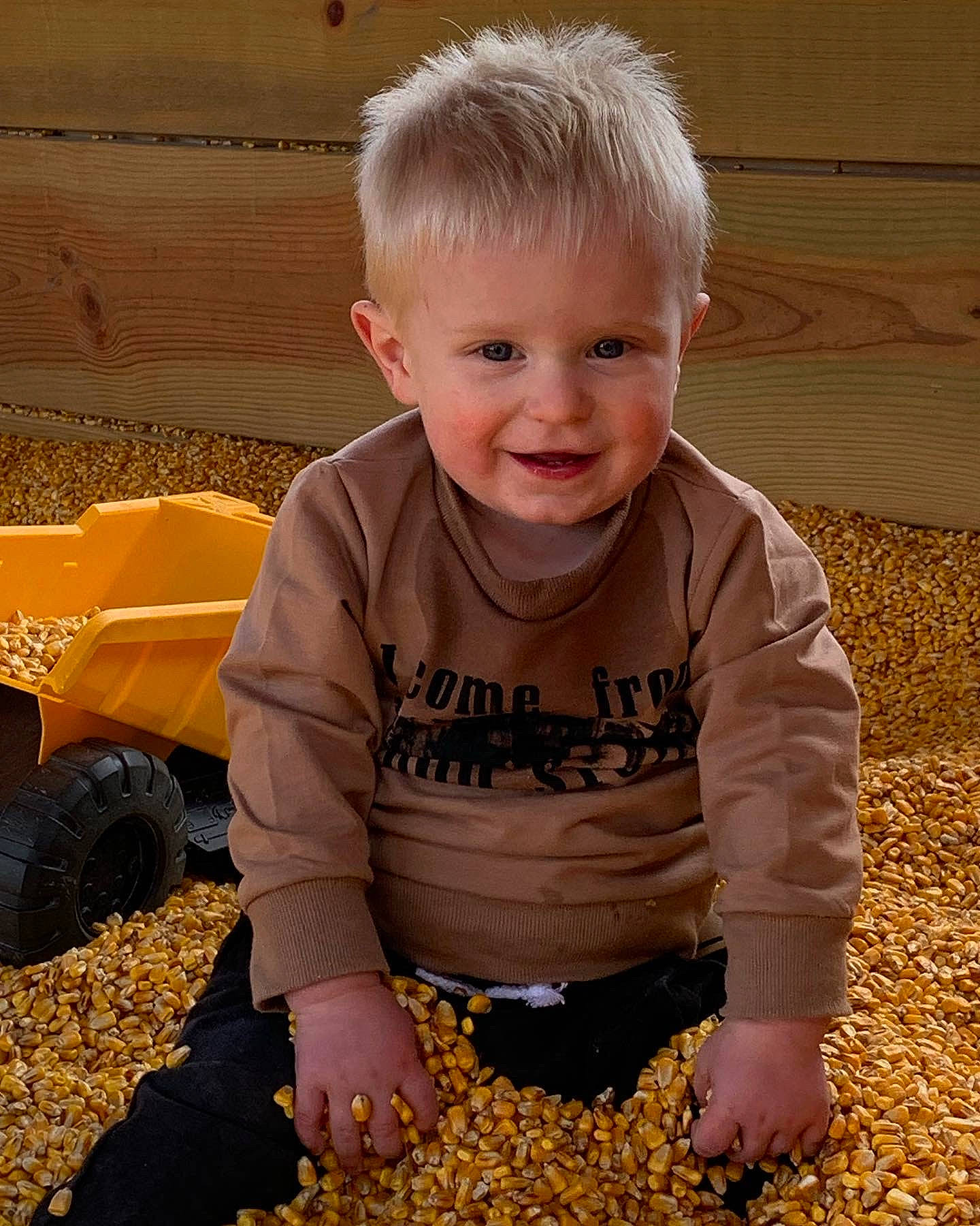 Reed is registered to the contest to win money with this photo: baby, baby_toddler_clothing, child, flooring, fun, grass, happy, joy, people, people_in_nature, person, play, sitting, sleeve, smile, soil, t_shirt, tire, toddler, wheel