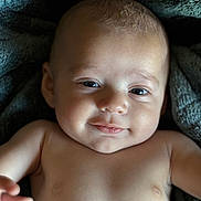 Michael joined the competition — help win amazing prizes! baby, infant, smile, face, skin, eyes, expression, blanket, soft, closeup, child, portrait, cute, happy, young, human, head, arm, newborn, lying