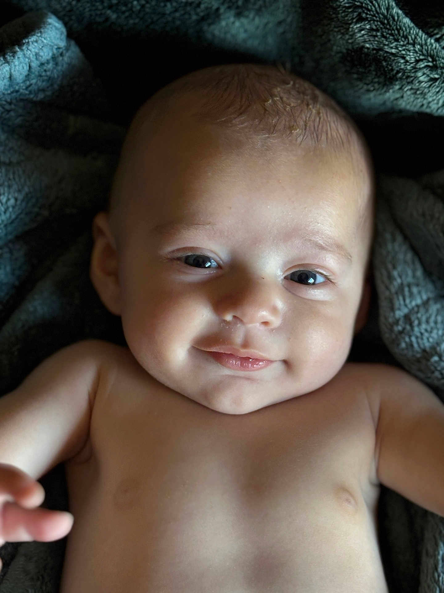 Michael joined the competition — help win amazing prizes! baby, infant, smile, face, skin, eyes, expression, blanket, soft, closeup, child, portrait, cute, happy, young, human, head, arm, newborn, lying