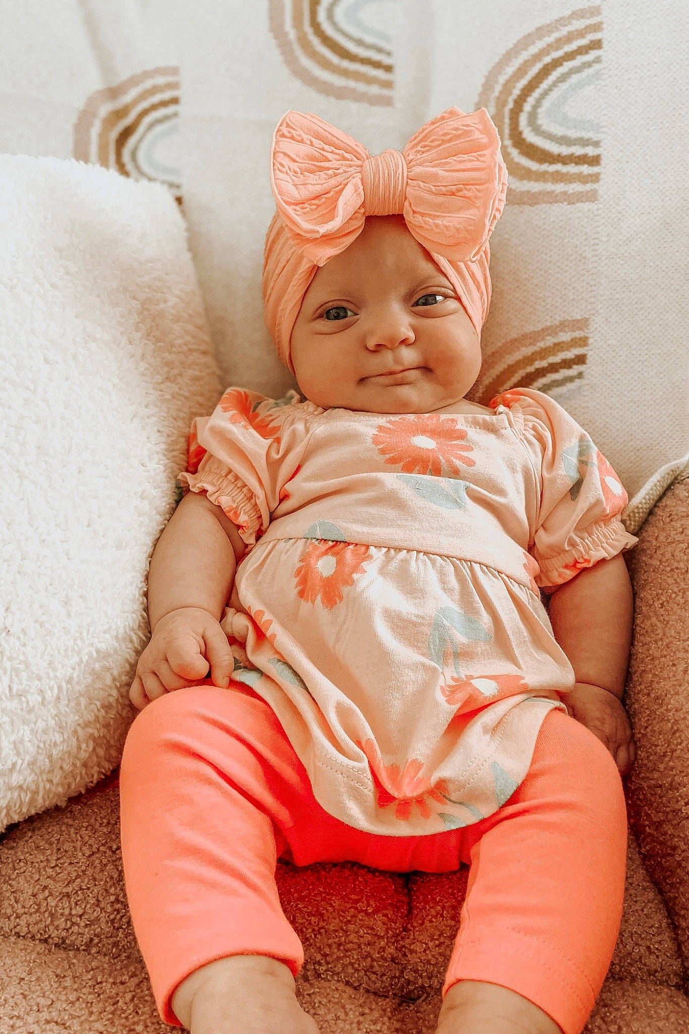 Novalee is registered to the contest to win money with this photo: baby, baby_toddler_clothing, comfort, costume_hat, eye, happy, headband, headpiece, headwear, human_leg, iris, lip, pattern, peach, person, pink, skin, sleeve, smile, textile