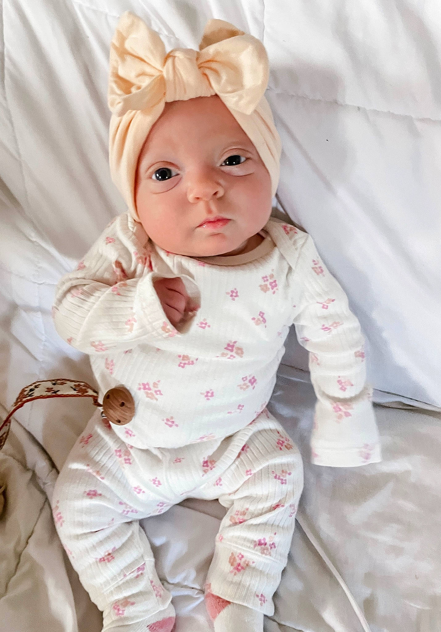 Novalee is registered to the contest to win money with this photo: baby, baby_products, baby_safety, baby_toddler_clothing, cheek, child, comfort, eye, fashion_accessory, happy, head, headpiece, linens, nose, pattern, person, pink, sitting, skin, sleeve
