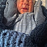 Asher is registered to the contest to win money with this photo: newborn, baby, infant, sleeping, smiling, portrait, striped_outfit, blanket, blue_blanket, bundled, cozy, sunlight, indoors, closeup, face, head, baby_clothing, knit, warm, peaceful