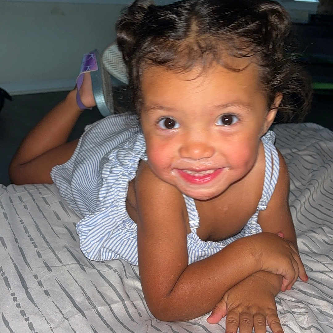 Simone is registered to the contest to win money with this photo: baby, bed, bedroom, bodypart, cushion, face, finger, furniture, hand, happy, head, homedecor, indoors, mouth, person, photography, portrait, room, smile, teeth