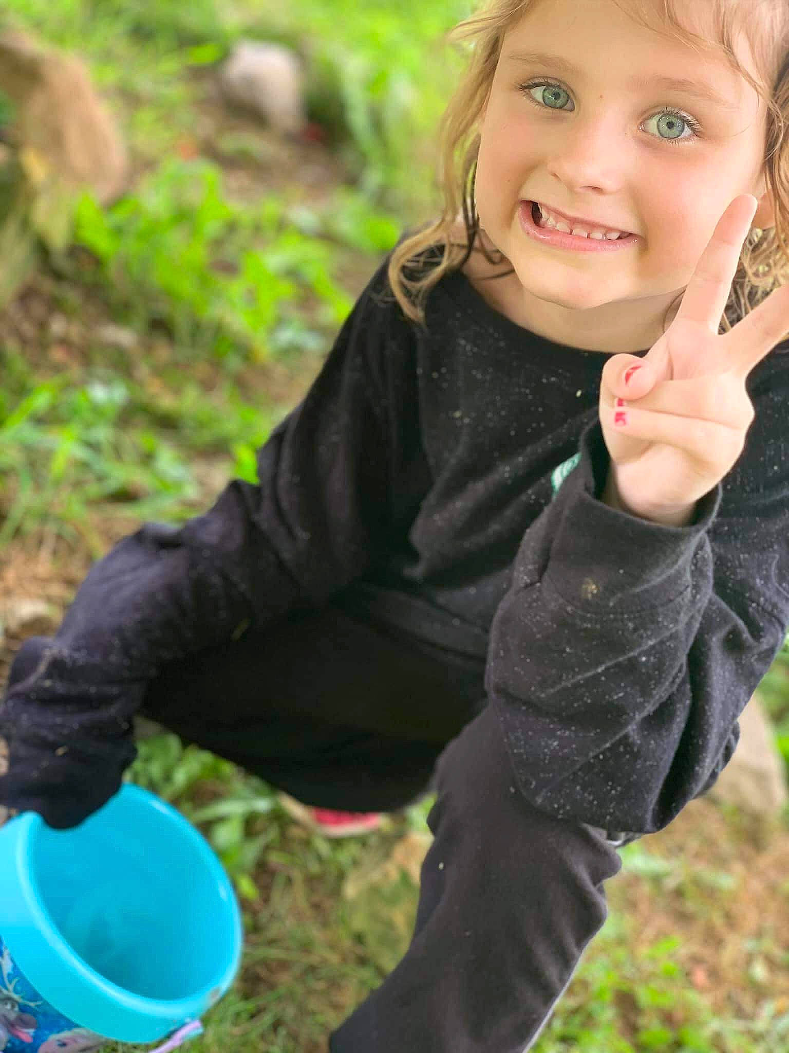 Kaylynn is registered to the contest to win money with this photo: blond, child, child_model, finger, fun, grass, hand, happy, joy, person, photography, plant, play, smile, soil, thumb, toddler, vacation