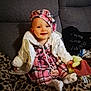 baby, child, smiling, plaid_dress, white_jacket, hat, pacifier, plush_toy, leopard_print, blanket, sitting, indoors, cute, person, face, headwear, cozy, comfort, home, young_child