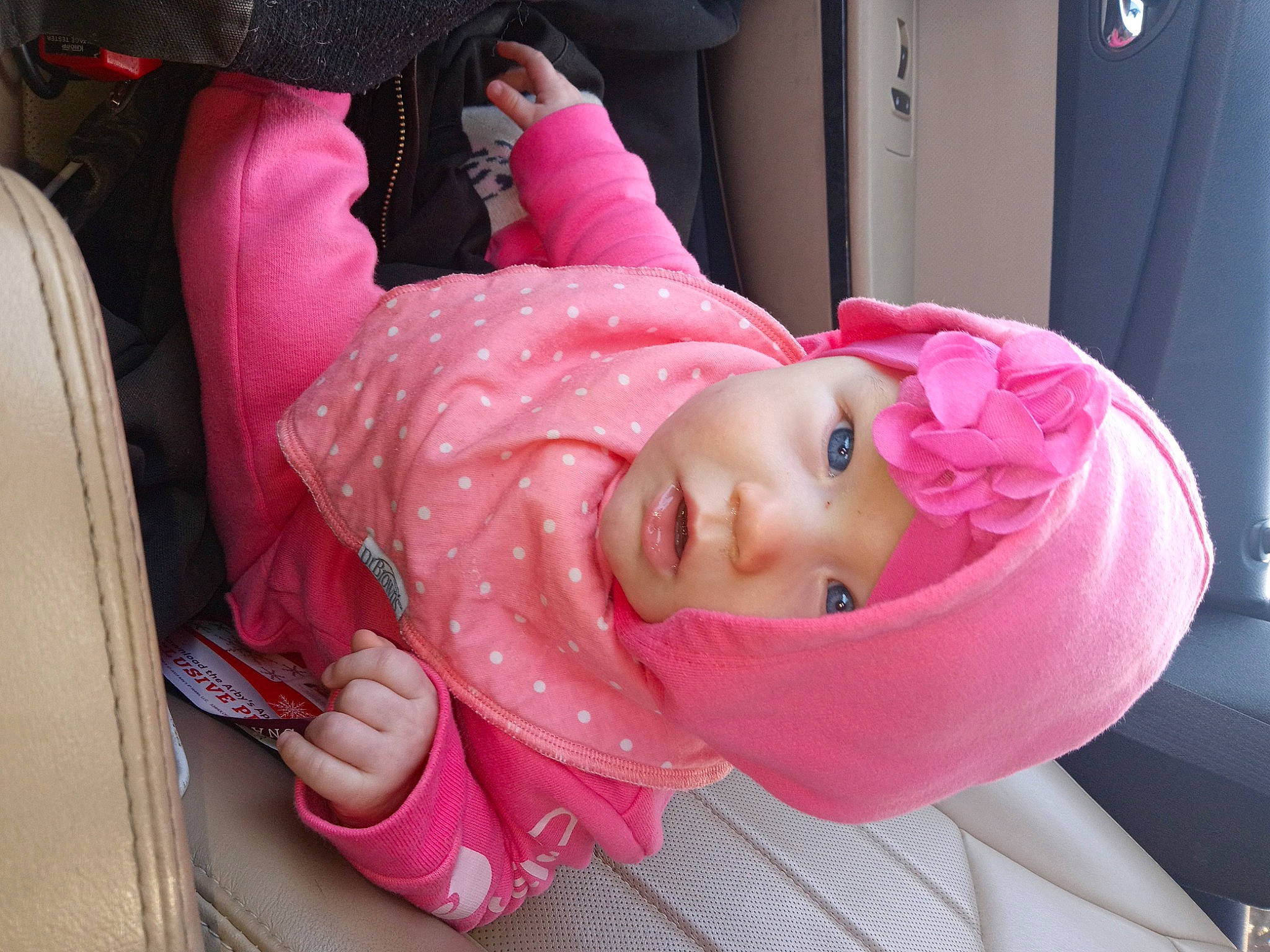 Tiana is registered to the contest to win money with this photo: baby, baby_products, baby_toddler_clothing, carmine, cheek, child, comfort, eyelash, fun, headwear, helmet, magenta, mouth, person, pink, plant, room, sitting, sunglasses, toddler