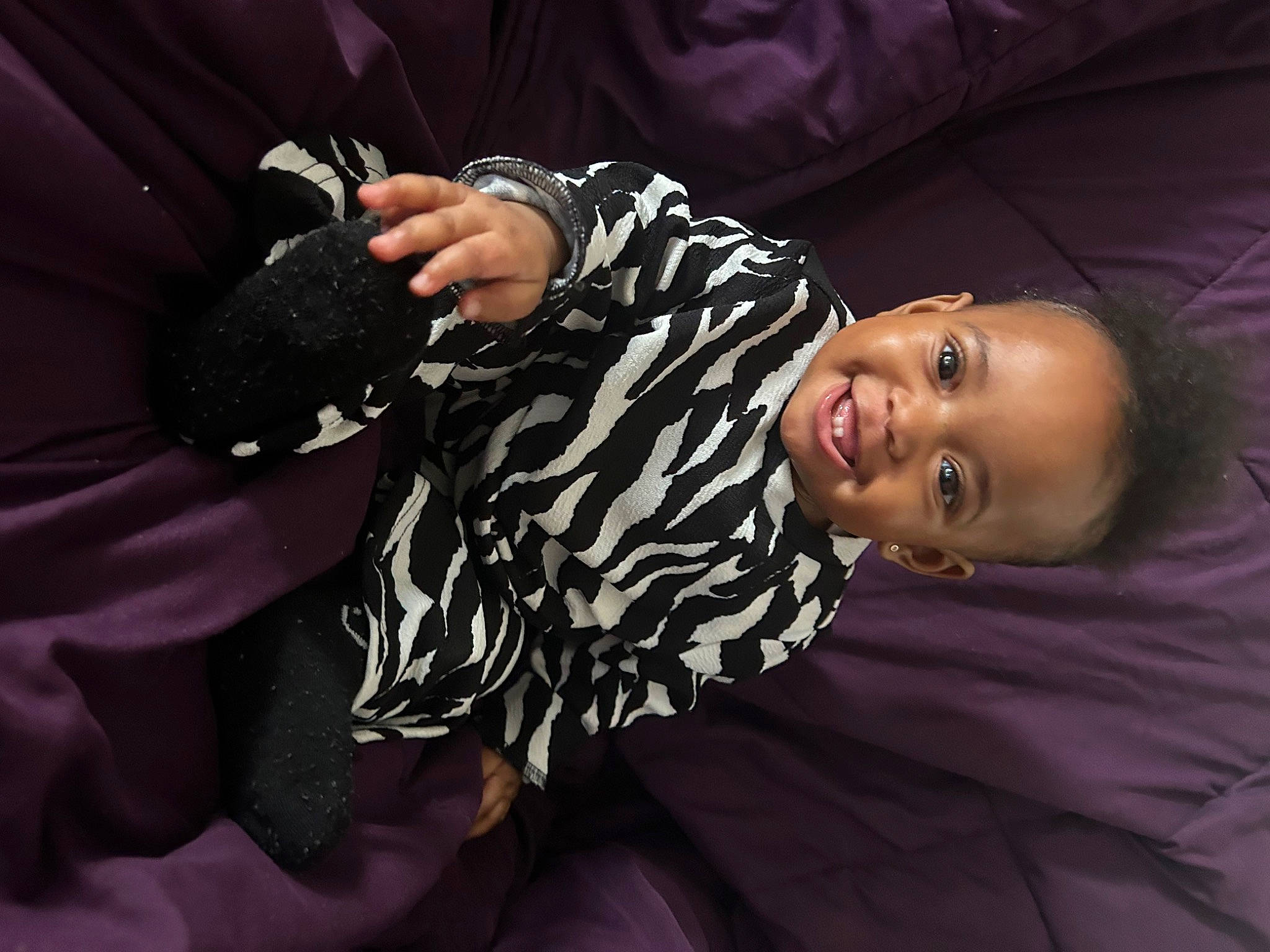 Malani is registered to the contest to win money with this photo: baby, baby_toddler_clothing, black_hair, child, darkness, event, fashion, fashion_accessory, flash_photography, fun, gesture, happy, joy, magenta, person, pink, purple, sitting, sleeve, smile