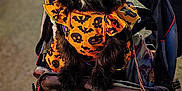 Luna is registered to the contest to win money with this photo: animal, bat_pattern, black_dog, blurred_background, celebration, costume, dog, ears, festival, halloween_costume, leash, nighttime, orange_clothing, outdoor, people, pet, pet_clothing, pumpkin_pattern, skull_pattern, stroller