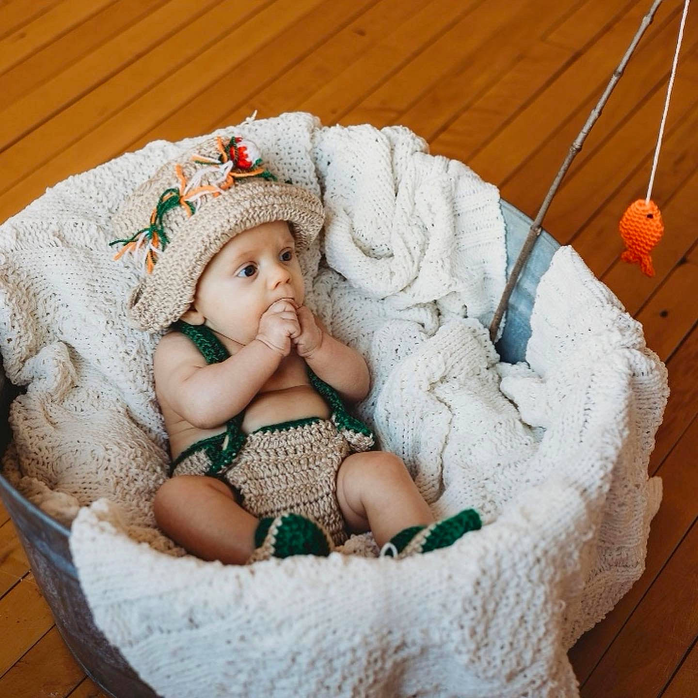 Westley is registered to the contest to win money with this photo: baby, baby_products, baby_sleeping, baby_toddler_clothing, basket, cap, cheek, child, comfort, grass, hair_accessory, headgear, headwear, jewellery, knit_cap, linens, pattern, person, sitting, skin