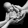 newborn, baby, hands, black_background, monochrome, portrait, peaceful, sleeping, adult_hands, skin, closeup, tenderness, family, love, care, infant, wrinkles, fingers, feet, studio