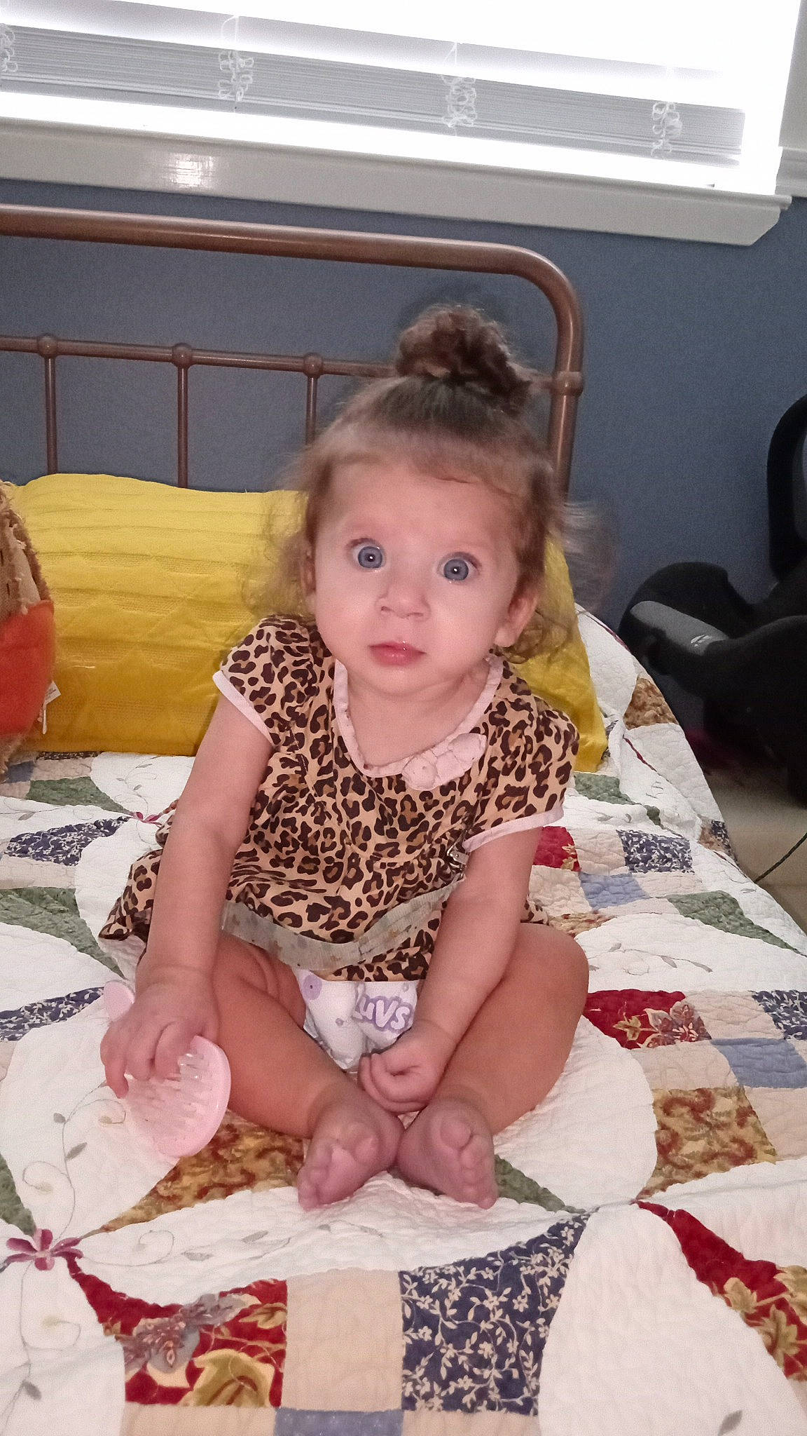 Cora is registered to the contest to win money with this photo: baby, baby_toddler_clothing, child, comfort, flooring, foot, fun, hairstyle, happy, human_leg, linens, pattern, person, play, room, sitting, sleeve, smile, thigh, toddler