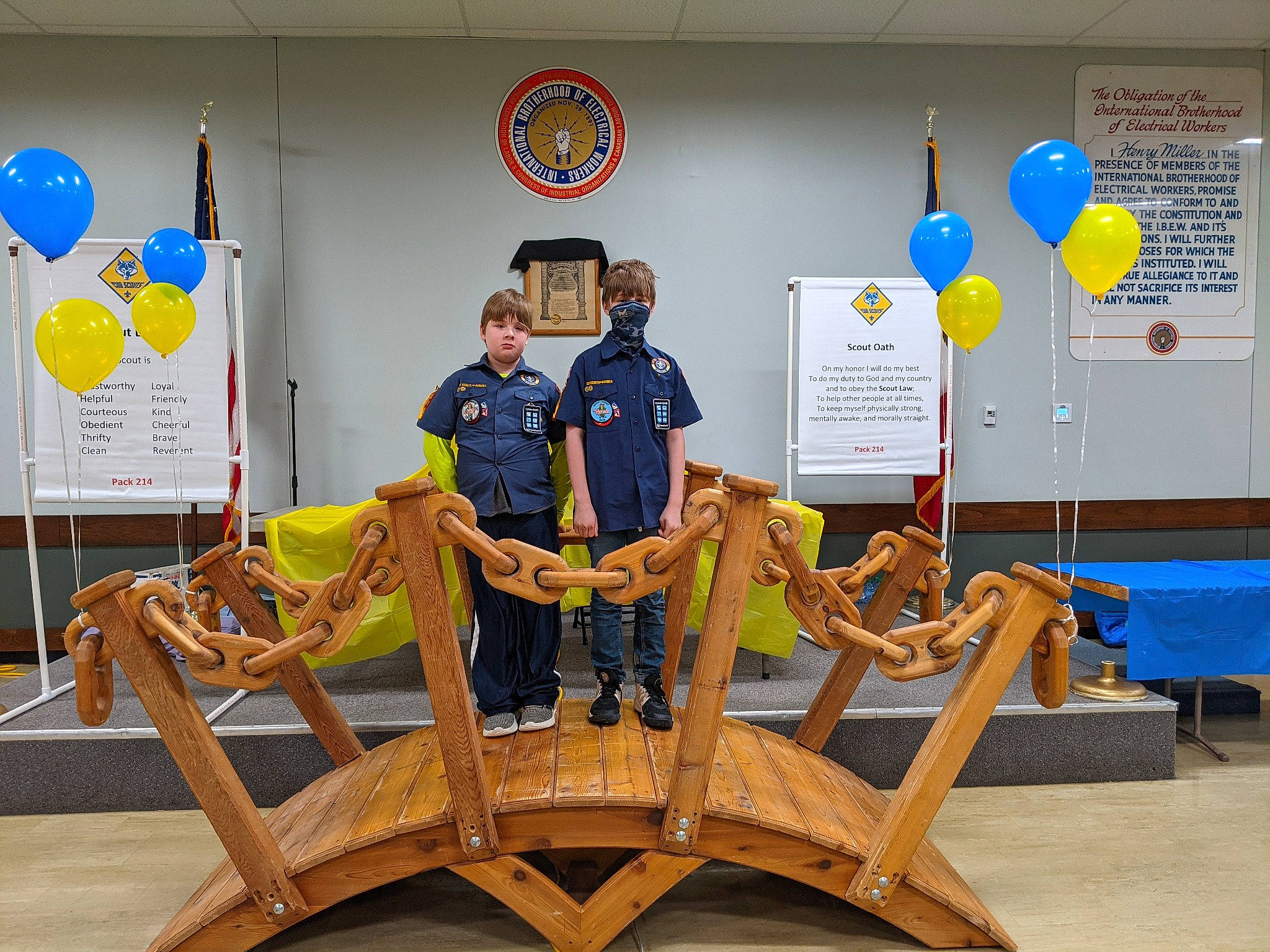 Seth is registered to the contest to win money with this photo: advertising, art, balloon, collection, event, flag, flooring, fun, job, leisure, logo, person, picture_frame, recreation, room, team, tourist_attraction, visual_arts, wheel, wood