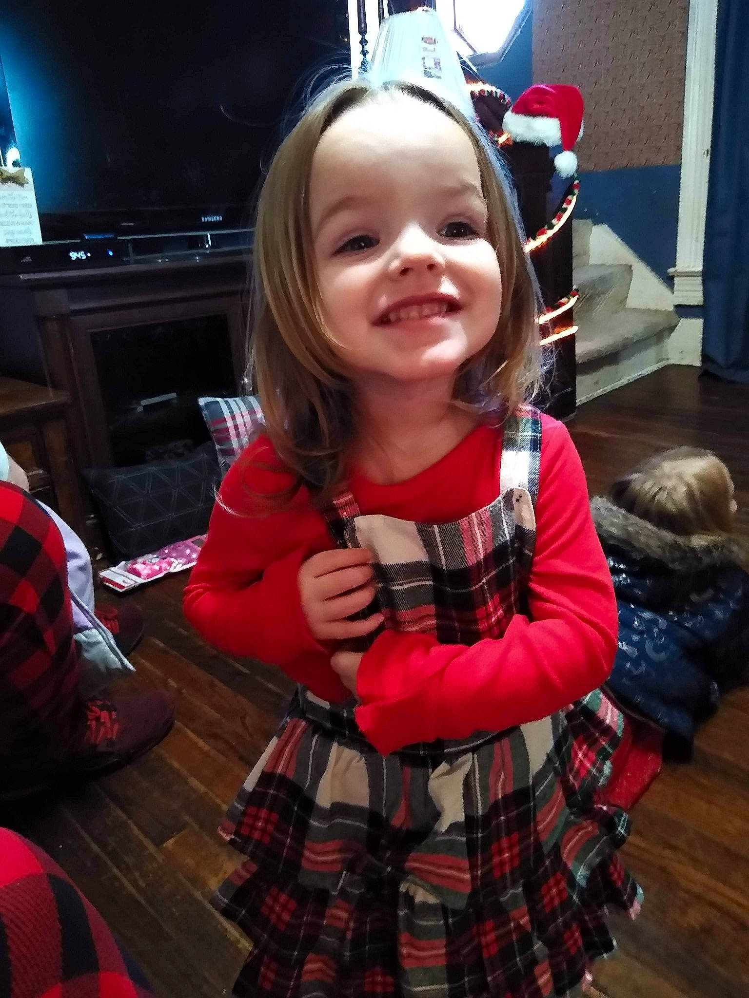 Everlee is registered to the contest to win money with this photo: black, carmine, child, design, event, facial_expression, fashion, flooring, fun, happy, joy, pattern, person, plaid, red, room, sitting, skin, sleeve, smile