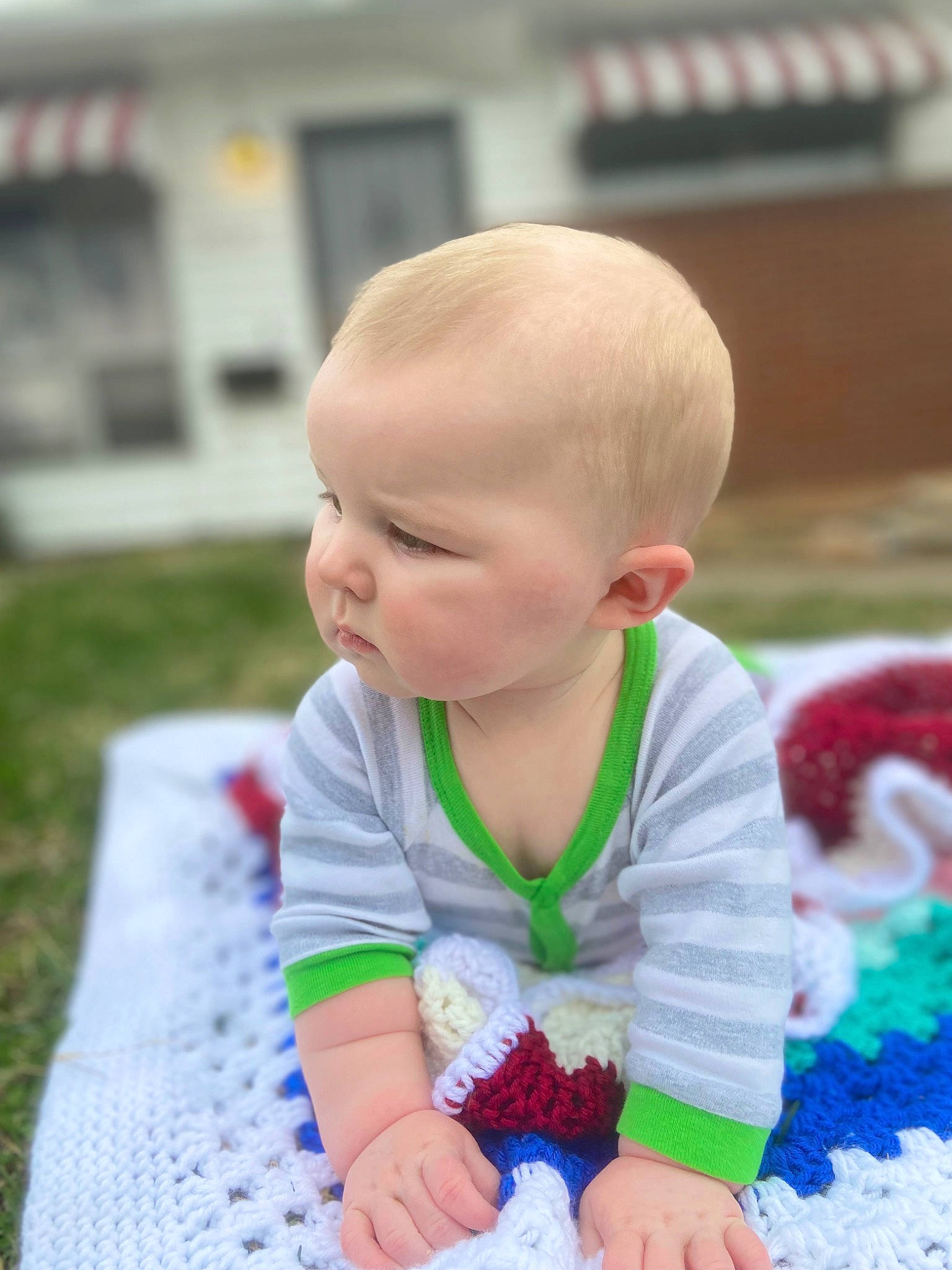 Travis is registered to the contest to win money with this photo: baby, baby_products, baby_toddler_clothing, cheek, child, flooring, fun, grass, happy, iris, leisure, pattern, person, play, recreation, sitting, skin, t_shirt, toddler, tummy_time