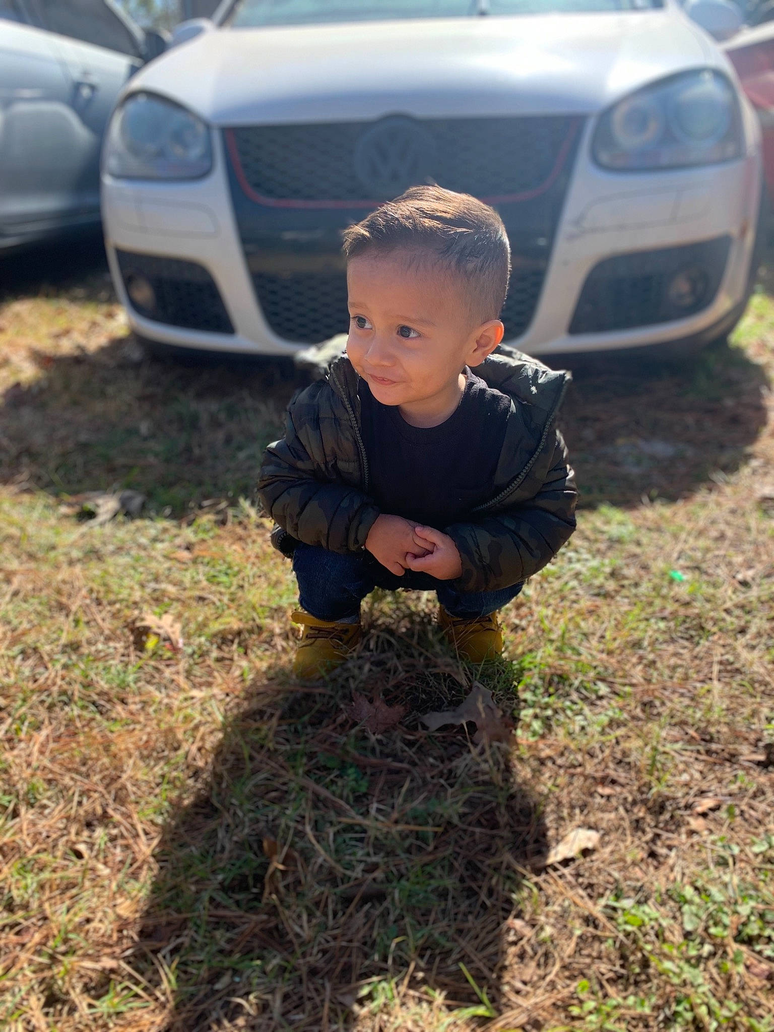 Elian joined the competition — help win amazing prizes! automotive_design, automotive_exterior, automotive_lighting, automotive_tire, bumper, car, family_car, grass, grille, headlamp, hood, mid_size_car, motor_vehicle, person, personal_luxury_car, plant, rim, tire, toddler, vehicle