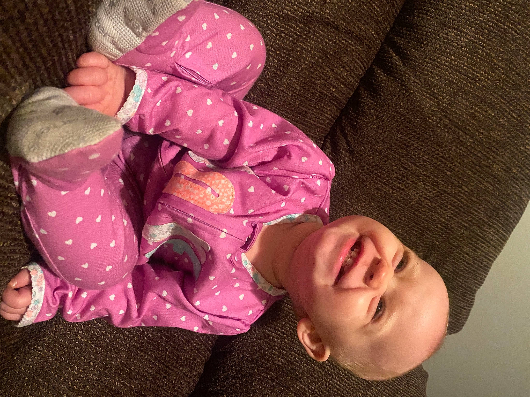 Briar is registered to the contest to win money with this photo: baby, baby_toddler_clothing, cheek, comfort, eye, finger, happy, head, headgear, human_body, joy, leg, mouth, nose, person, pink, purple, skin, sleeve, smile