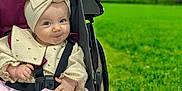 Maddison is registered to the contest to win money with this photo: baby, child, stroller, headband, bow, blanket, outdoor, greenery, grass, smile, cute, infant, clothing, seatbelt, park, nature, portrait, happy, person, babyclothes