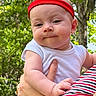Joey is registered to the contest to win money with this photo: baby, infant, child, headband, red, white_shirt, hand, arm, outdoor, greenery, trees, nature, person, portrait, cute, expression, hold, striped_clothing, skin, summer