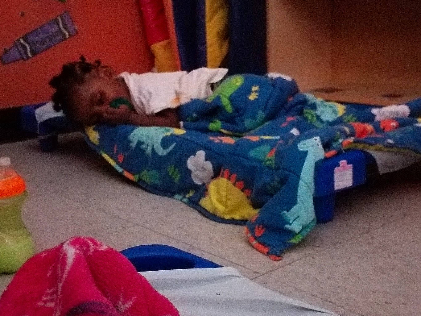 Jakobe is registered to the contest to win money with this photo: carmine, child, comfort, flooring, fun, human_body, human_leg, leg, leisure, linens, nap, person, plastic, play, room, sitting, toddler