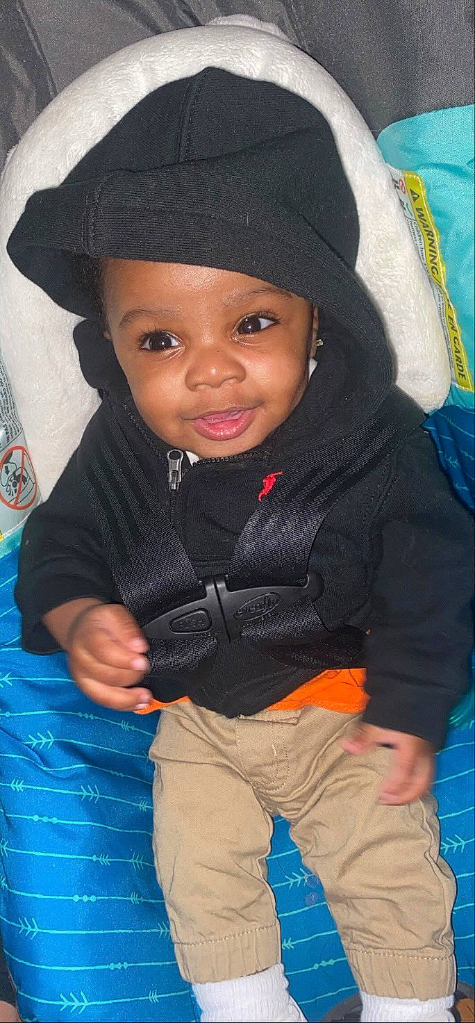 Jakobe is registered to the contest to win money with this photo: baby, blue, cap, cheek, child, cool, electric_blue, eye, fashion_accessory, flash_photography, fun, happy, headgear, headwear, nose, person, sitting, skin, sleeve, smile