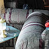 dog, couch, living_room, lamp, glass_table, furniture, curtains, patterned_fabric, cozy, indoor, pet, peeking, home, sitting, decor, soft_lighting, curious, quiet, relaxing, shadow