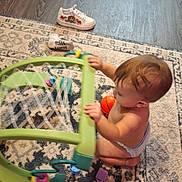 Ryker joined the competition — help win amazing prizes! baby, baby_playing, blocks, brown_hair, carpet, child, diaper, floor, furniture, home, indoor, orange_ball, playing, profile, rug, shoes, sitting, toddler, toy, toy_frame