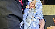 Ryker joined the competition — help win amazing prizes! adult, baby, beard, blanket, blue_blanket, cradling, family, glasses, headset, holding, indoor, infant, man, microphone, newborn, portrait, seated, sleeping, table, 抱抱