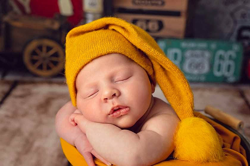 Louis participe au concours pour gagner de l'argent avec cette photo : baby, baby_sleeping, baby_toddler_clothing, cap, cheek, child, comfort, eye, fun, happy, headgear, headwear, knit_cap, mammal, orange, person, skin, tire, toddler, wheel
