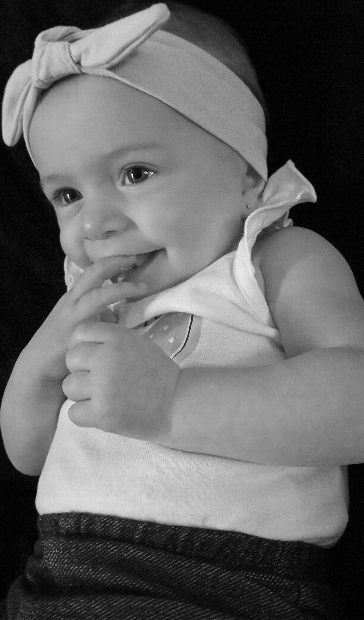 Jasmin is registered to the contest to win money with this photo: baby, baby_toddler_clothing, black, black_and_white, cap, cheek, eye, eyebrow, flash_photography, gesture, hand, hat, headgear, headwear, iris, lip, person, photograph, skin, smile