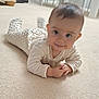 baby, infant, child, lying_down, carpet, white_onesie, smile, hands, face, indoors, floor, cute, young_child, baby_clothes, head, person, carpeted_floor, happy, home, furniture