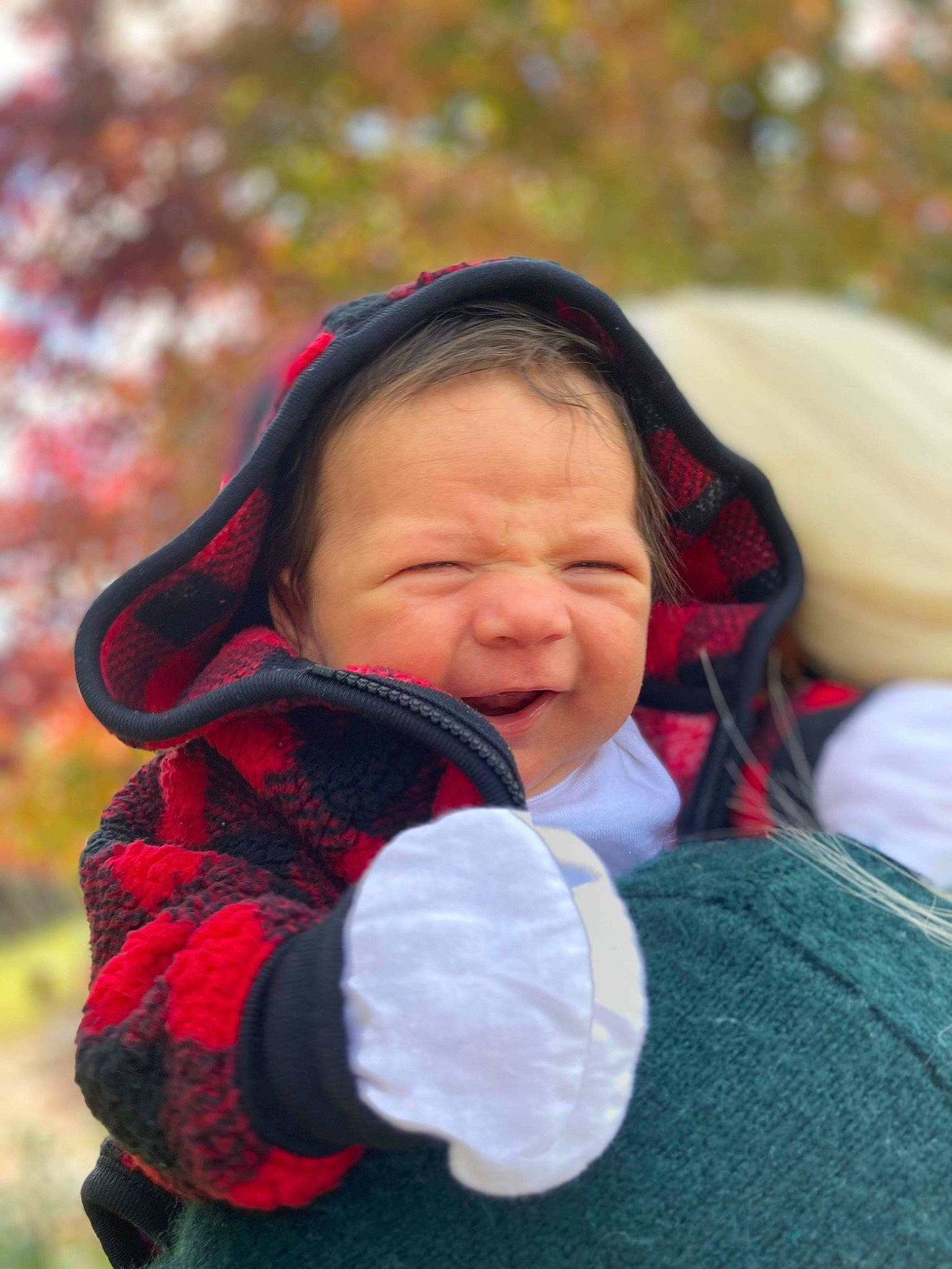 Jonah is registered to the contest to win money with this photo: baby, child, comfort, facial_expression, fun, grass, happy, head, jacket, knit_cap, leisure, lip, outerwear, people_in_nature, person, plant, skin, toddler, tree, winter