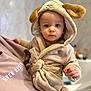 baby, bodypart, bonnet, clothing, coat, face, fashion, finger, hand, hat, head, hood, hoodie, knitwear, newborn, person, photography, portrait, sweater, sweatshirt