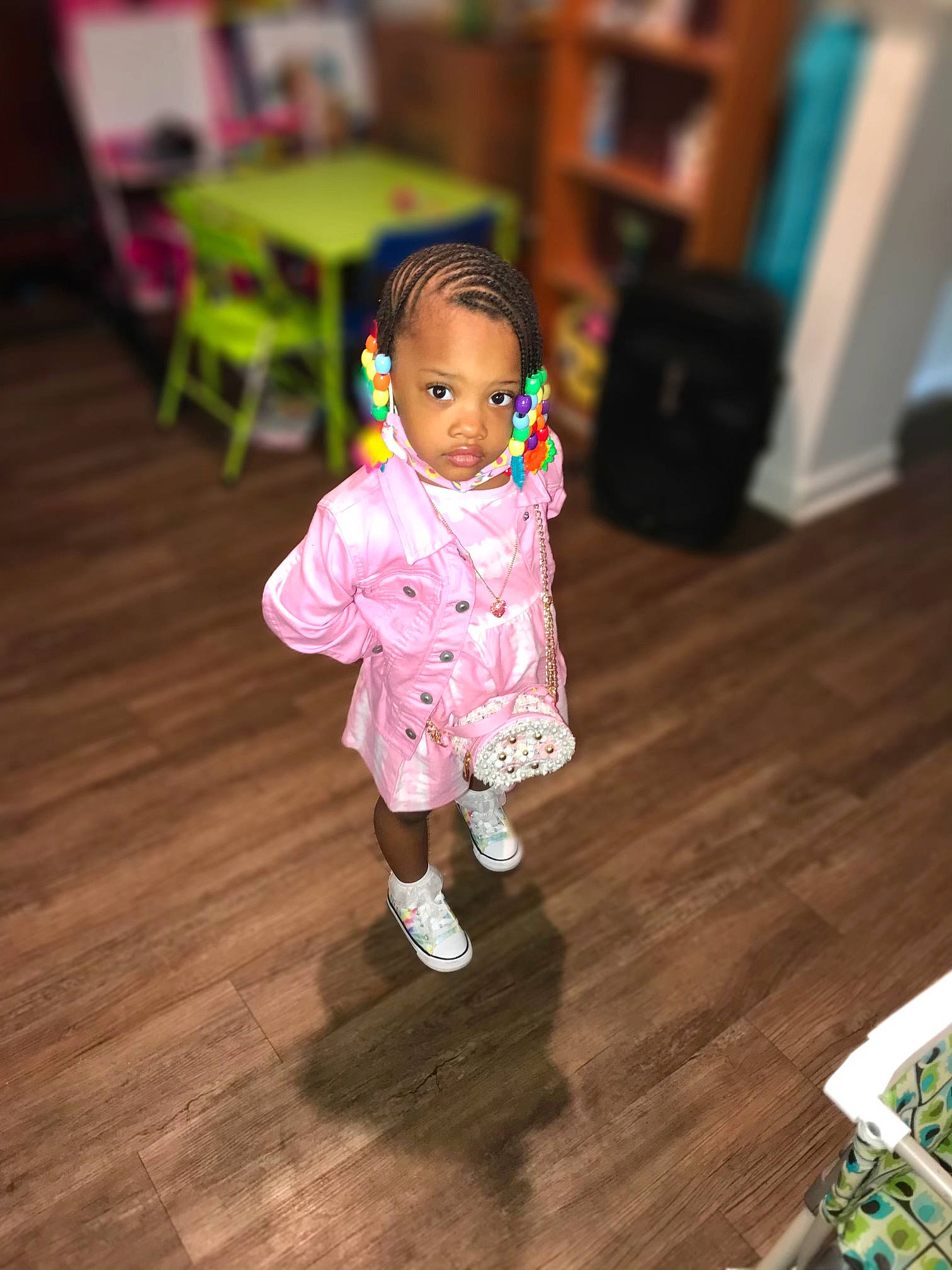 Alice is registered to the contest to win money with this photo: baby, baby_toddler_clothing, chair, child, door, dress, event, eye, floor, flooring, happy, hardwood, laminate_flooring, leg, magenta, person, room, toddler, toy, wood