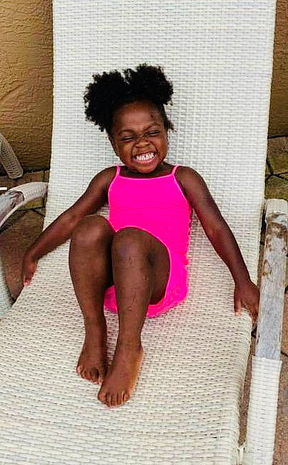 Cherish is registered to the contest to win money with this photo: child, child_model, finger, human, human_leg, joint, joy, leg, person, pink, shoulder, sitting, smile, thigh, toddler