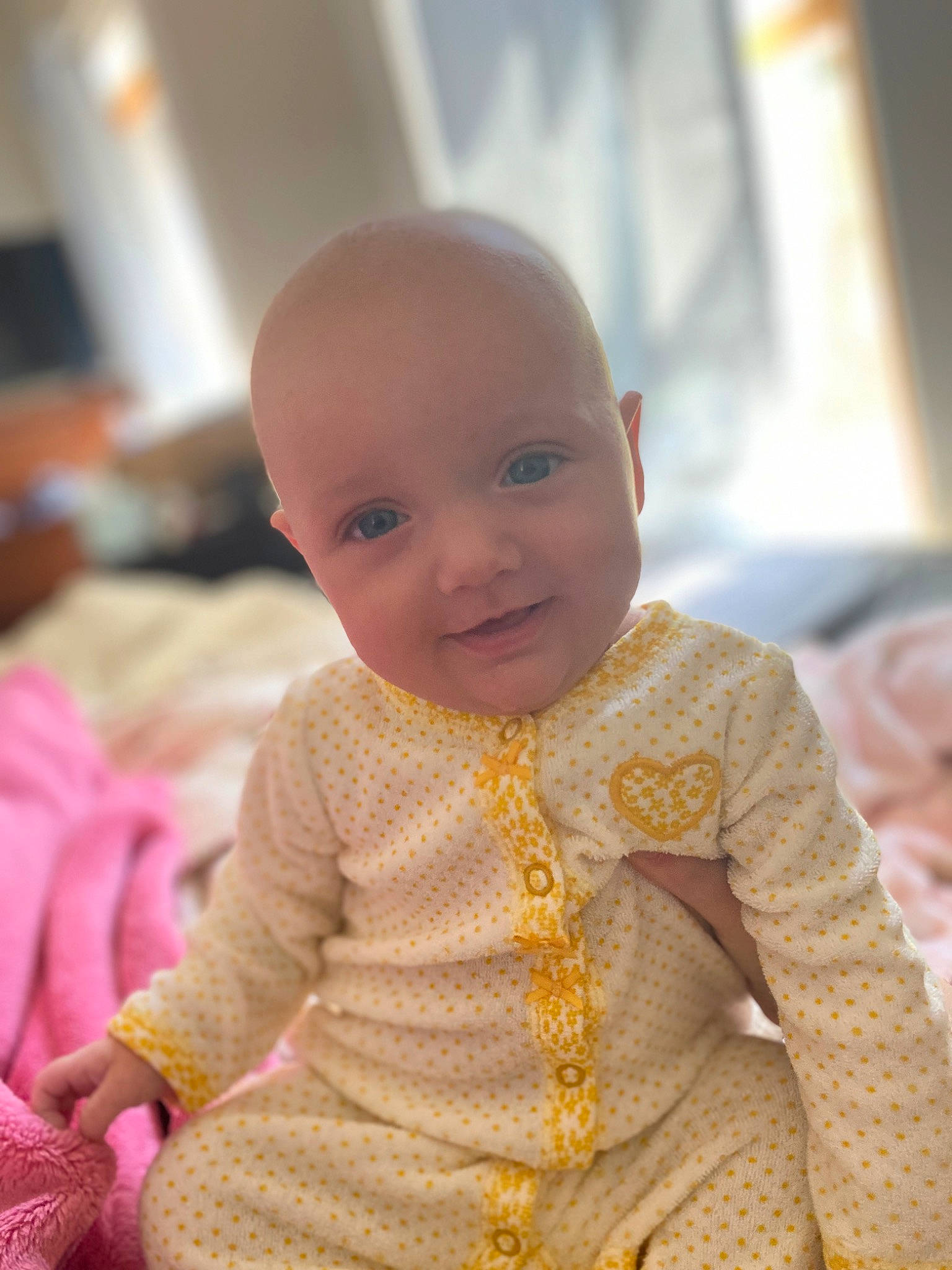 Amariah joined the competition — help win amazing prizes! baby, baby_toddler_clothing, cheek, child, facial_expression, flooring, fun, happy, iris, lip, magenta, nose, person, pink, room, sitting, skin, sleeve, smile, toddler