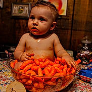 Oliver joined the competition — help win amazing prizes! baby, child, cheese_puffs, snack, bowl, tablecloth, milestone_sign, ten_months, messy, curious, orange, food, indoor, portrait, cheesy_fingers, face, hair, celebration, sitting, hands