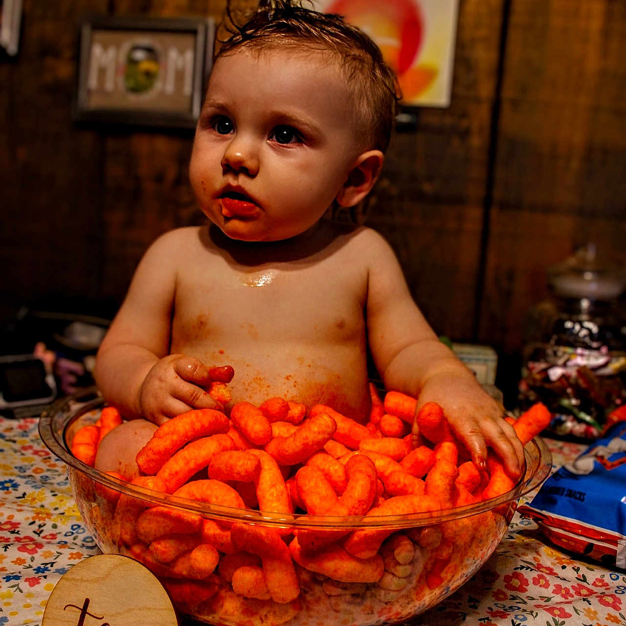 Oliver joined the competition — help win amazing prizes! baby, child, cheese_puffs, snack, bowl, tablecloth, milestone_sign, ten_months, messy, curious, orange, food, indoor, portrait, cheesy_fingers, face, hair, celebration, sitting, hands
